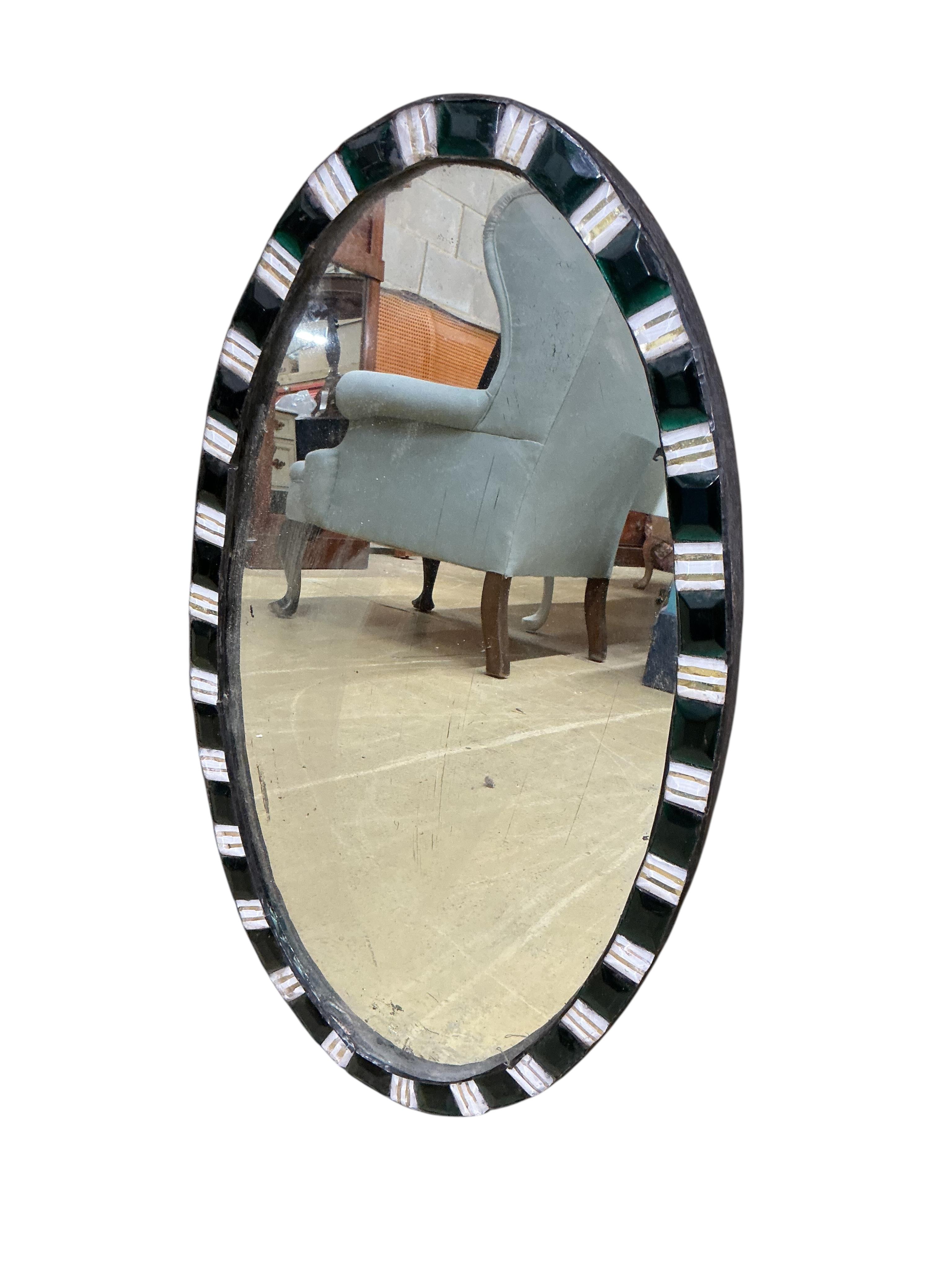 An oval Irish style wall mirror, width 37cm, height 65cm